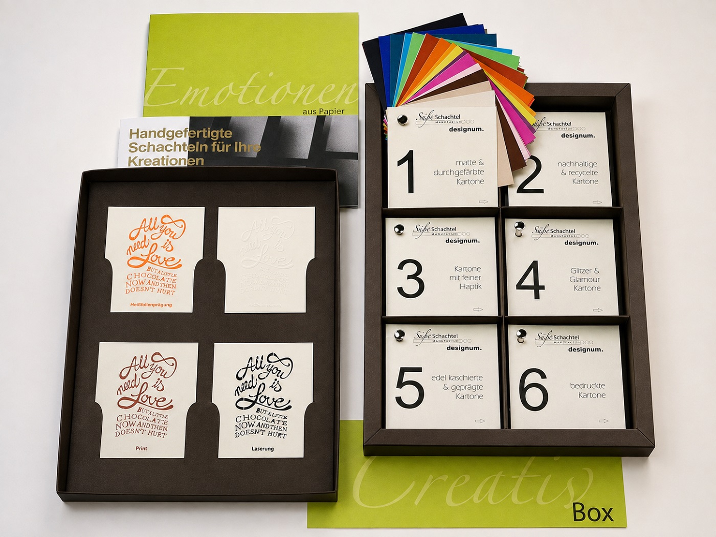 Creative-Box geöffnet: Schokoladenbraun außen, Crème innen, Logo in Warmgold-Prägung